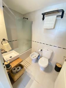 a bathroom with a toilet and a shower and a sink at Espacio Arena in Buenos Aires +27 photos