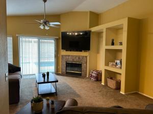 a living room with a couch and a fireplace at Walking Distance to Stagecoach in Indio
