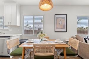 a kitchen and living room with a table and chairs at The Stylish Cozy Bungalow in North Park in San Diego +6 photos