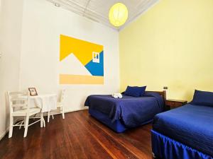 Una cama o camas en una habitación de La Galería B&B
