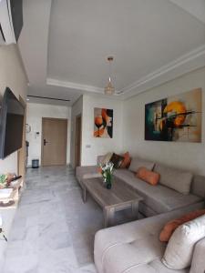 a living room with a couch and a table at Ocean Park Zenata City Eco in Casablanca