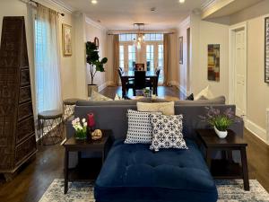 a living room with a blue couch and a table at 5 Bedroom Huge House in Best Location Parking Fireplace Back Yard in Chicago +43 photos