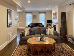 a living room with a couch and a table at 5 Bedroom Huge House in Best Location Parking Fireplace Back Yard in Chicago