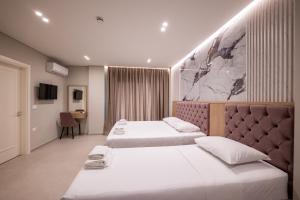 Postel nebo postele na pokoji v ubytování Koko Hotel