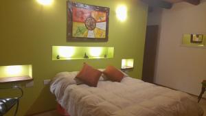 a bedroom with a bed with two pillows on it at Mantram Armonía in Mendoza