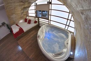 a large bath tub in a room with a window at Loft & Spa in Bordeaux