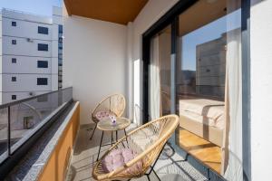 a balcony with two chairs and a table at Cozy Coastal Bliss 2 in Ulcinj