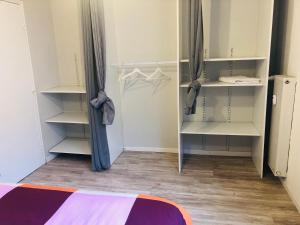 a bedroom with white shelves and a closet at Superbe T3 calme proche de Lille - La Madeleine in La Madeleine +9 photos