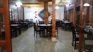 a dining room with tables and chairs in a restaurant at Apartment&Rooms "Globus" Mostar in Mostar