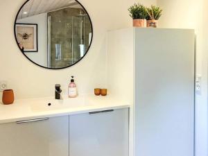 a bathroom with a mirror and a sink at 4 star holiday home in Løgstør-By Traum in Løgsted +32 photos
