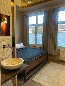 a bedroom with a bed with a sink and a window at Wohnen im Beauty Salon- im Herzen von Greven in Greven
