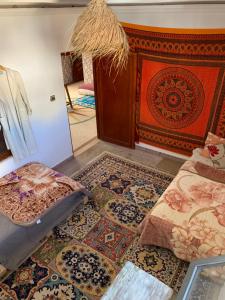 a room with carpets on the floor and a wall at House of Sun guesthouse in Tamraght Ouzdar +18 photos
