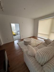 a living room with a large bed with a couch at Modern Unit Near Glendale Galleria and Walk to Shopping & Dining! in Glendale
