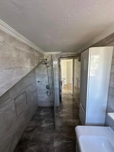Un baño con ducha, inodoro y lavabo. en VİLLAASUR inst-mariyatourdidim, en Didim