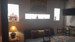 a living room with a couch and a table with a lamp at Mantram Armonía in Mendoza