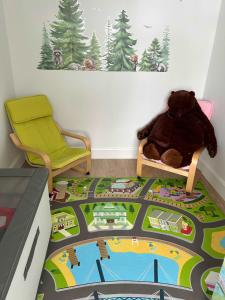a teddy bear sitting on a chair in a room at Forêt Blanche - Sauna et Spa in Pont-Rouge