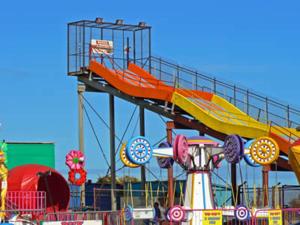 a ride at a carnival with a roller coaster at Lovely Chalet 15, Seadell Park in Hemsby