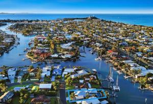 an aerial view of a harbor with houses and boats at WATERFRONT HOME BORDERING MOOLOOLABA in Buddina
