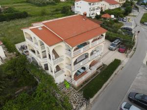 una vista sul tetto di una casa bianca con tetto arancione di Apartmani Ćućić a Lopar