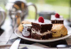 a plate with a piece of cake and a piece of bread at Eddrachilles Hotel in Scourie +42 photos