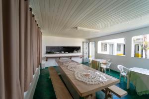 a room with a wooden table and a dining room at Pousada Vila Rica in Bonito