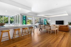 a kitchen and living room with a table and chairs at BEACH01- Mooloolaba Beachfront Apartment with Private Pool in Mooloolaba