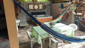 a hammock in a kitchen with a table and a sink at Chez HENRIETTE in Terre de Bas