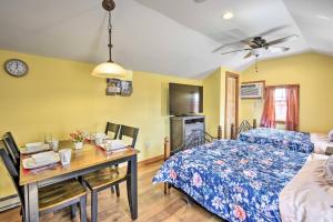 a bedroom with a bed and a desk with a table at Equestrian House Suites in Pleasant Mount