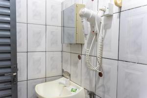 a bathroom with a phone on the wall next to a sink at Pousada Vila Rica in Bonito +45 photos
