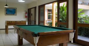 a pool table in a living room with at Sueds Premium in Porto Seguro