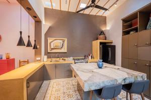 a large kitchen with a large marble counter top at Casa La Escondida in Mérida