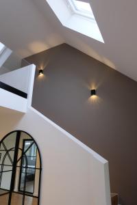 two lights on the ceiling of a room with a window at Modern dream house with private spa and gym in Norderstedt