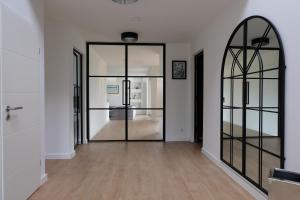 an empty hallway with a large glass door at Modern dream house with private spa and gym in Norderstedt