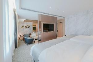 Ένα ή περισσότερα κρεβάτια σε δωμάτιο στο Izumi Boutique Hotel