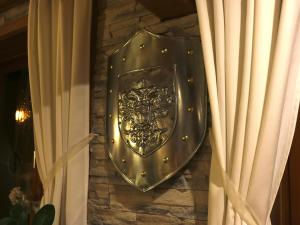 a metal shield on the side of a stone wall at Hotel Gasthof Bären in Weingarten +30 photos
