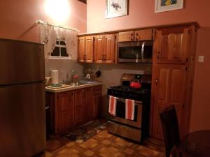a kitchen with wooden cabinets and a stove top oven at Boyce Guest House in Black Rock