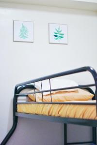 a bunk bed in a room with two pictures on the wall at MG Place -2 BR condo unit at SMDC Charm Residences, Cainta, Rizal, 1900 in Cainta