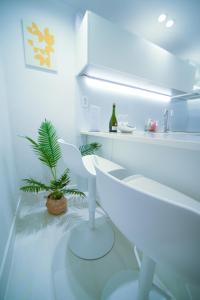 a white kitchen with a plant and a white counter at Stay Busan in Busan