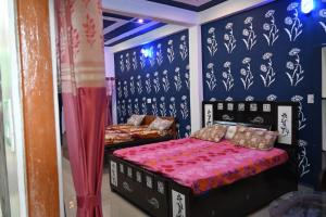 a bedroom with two beds and a blue wall at Pandey guest house in Masodha