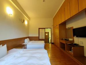 Uma cama ou camas num quarto em 復興青年活動中心 復興比雅山會館