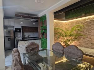 a living room with a glass table and chairs at Casa Navarro de paris in Tarapoto