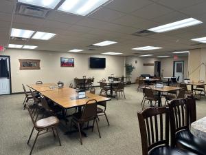 a conference room with tables and chairs and a tv at Selby Motel in Selby