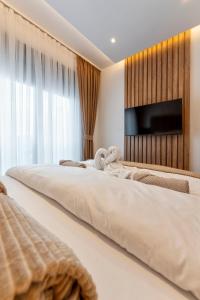 Postel nebo postele na pokoji v ubytování Gomax 3 M Lux apartman , Zlatibor