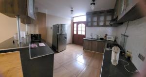 a kitchen with a refrigerator and a counter top at Giovi's house in Ilo