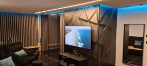 a room with a flat screen tv on a wall at SEA VIEW HAIFA Suite on the beach in Haifa