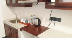 a kitchen counter with a sink and a coffee maker on it at Johans Villa Kandy in Kandy