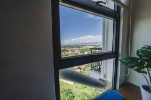 a window with a view of a city at JYL Royal Oceancrest Mactan Condo Staycation in Mactan Island