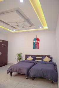 a bedroom with two beds and a ceiling at Blissful stays midst nature in Rishīkesh