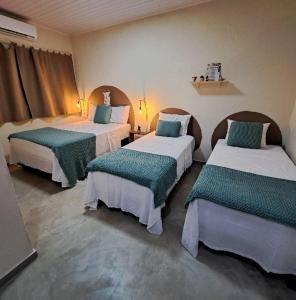 a hotel room with two beds in a room at Bangalôs Vila do Arraial in Arraial d'Ajuda +30 photos