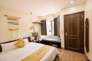 a bedroom with a bed and a window and a door at Pan House Bắc Hà in Bắc Hà